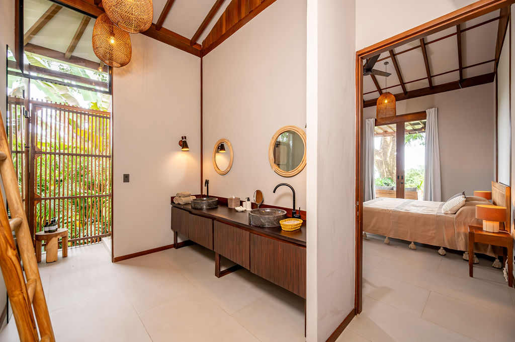 Primary vanity with the bedroom visible through the open doorway
