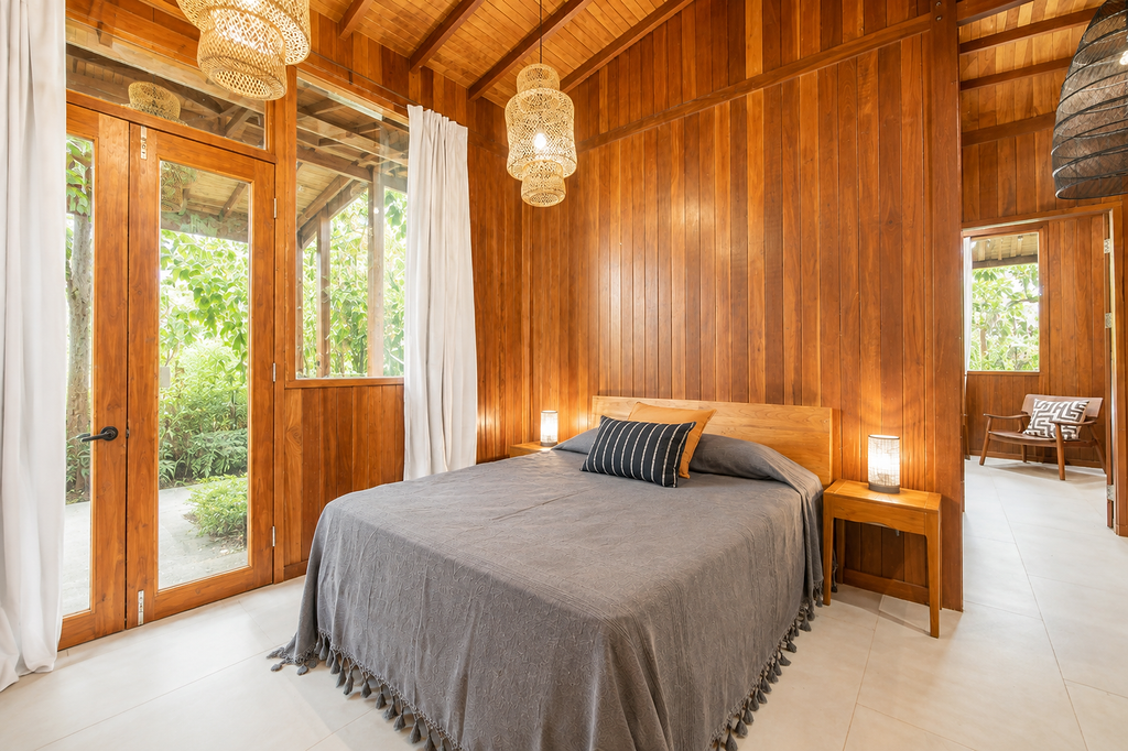 Jungle residence king bed in a teak-lined room with tropical outlook