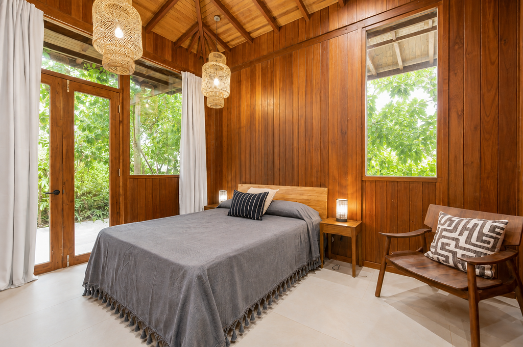 Warm all-timber bedroom with woven pendant lights