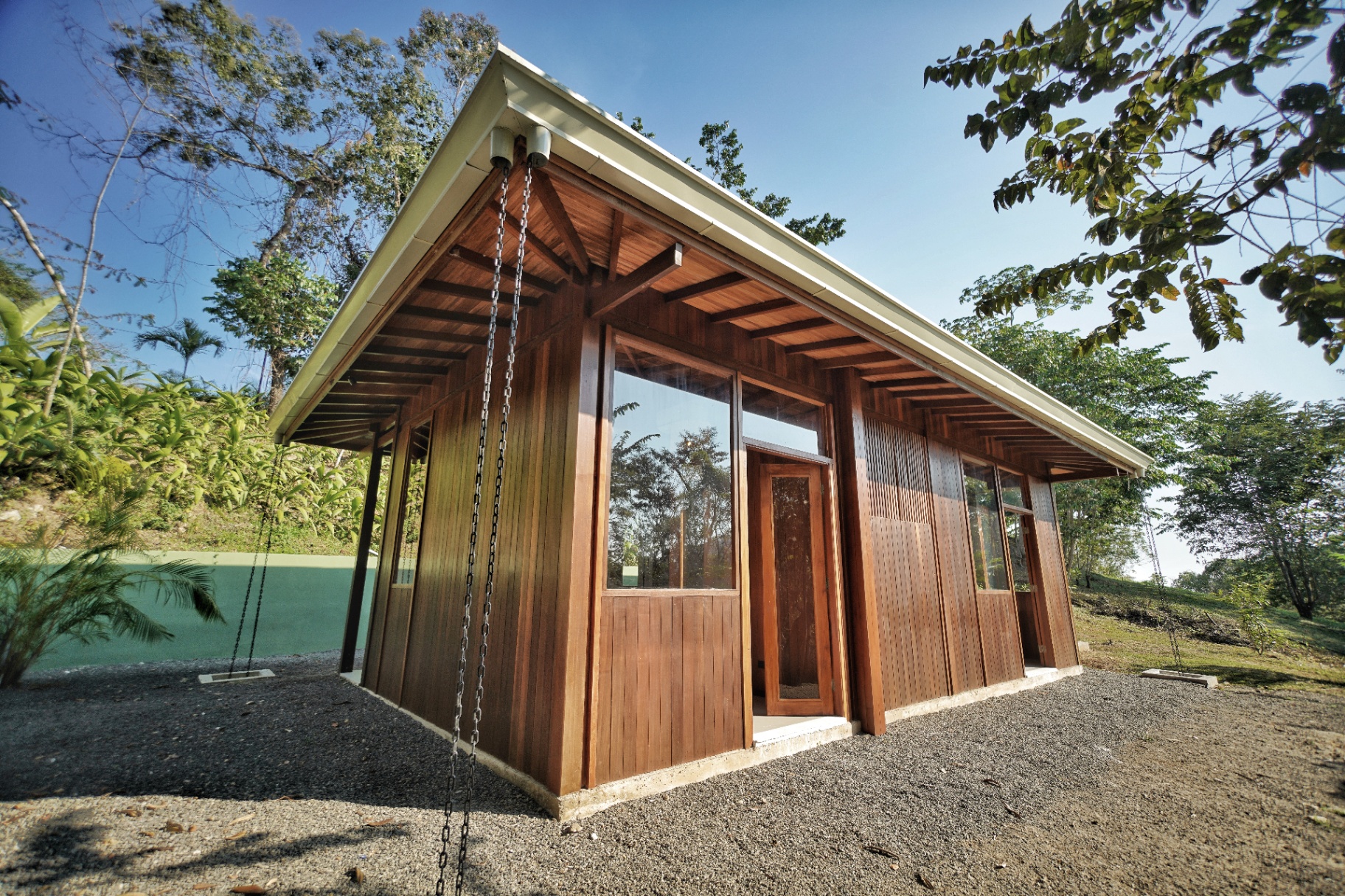 Jungle pavilion architecture, cantilevered roof and swing chains