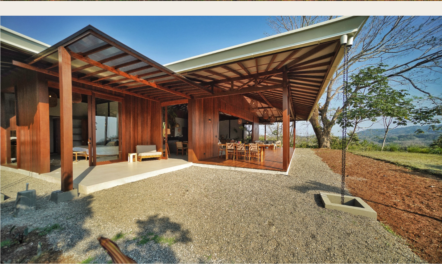 Main residence exterior corner view with covered terrace and timber cladding