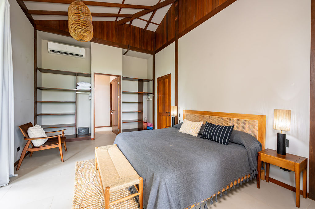 Bedroom two with king bed beneath a vaulted timber ceiling